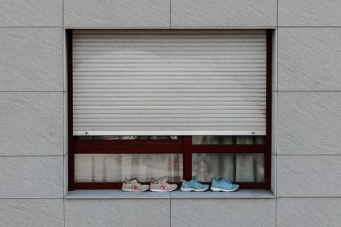 Two pairs of trainers on a window ledge in Coruna Spain Stock Photos