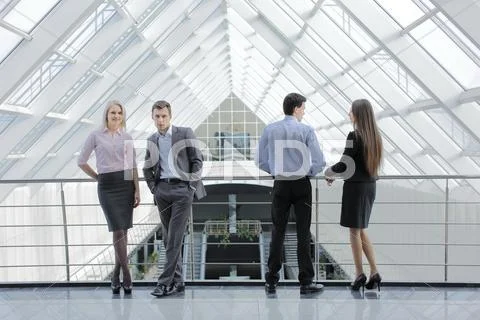 Two pairs of young successful men and women Stock Photos