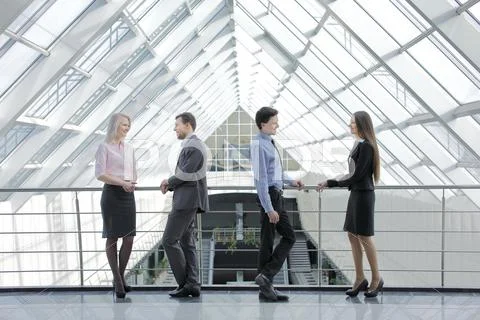 Two pairs of young successful men and women Stock Photos