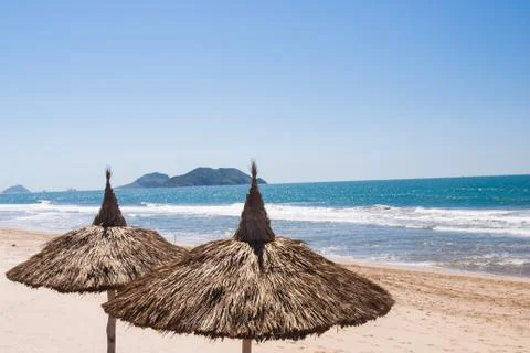 Two palapas on empty mexican beach Stock Photos