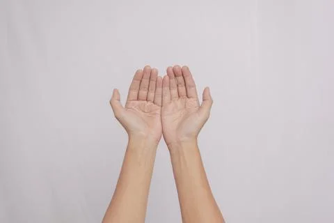 Two palms open up as a gesture of peace and giving thanks, isolated on whit.. Stock Photos