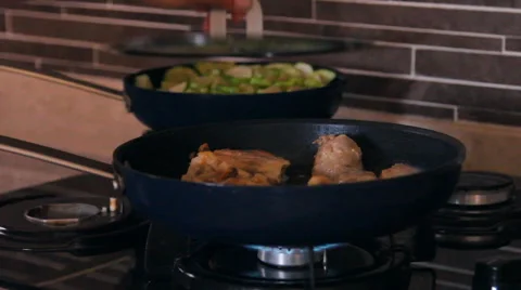 Two pan on the fire, vegetable marrow, zucchini mix in the pan, chicken fried Stock Footage 40216574