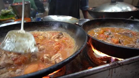 Two pans bubbling with tomato meat stew Video stock 314583599