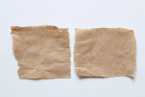 Two paper brown cards torn at the edges in the shape of a rectangle on a wh.. Stock Photos