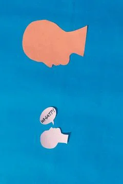 Two Paper Human face with what Question Mark on speech bubble isolated on blu Stock Photos