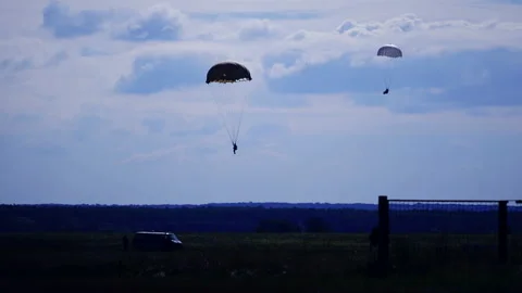Two parachutists descending to the ground.  Video stock 230921090