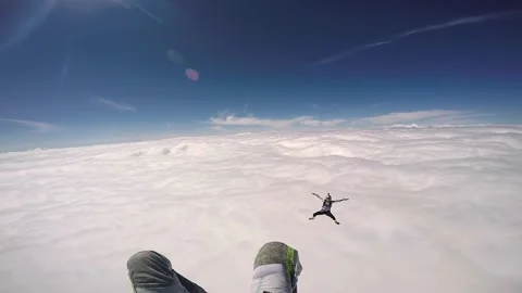 Two parachutists fall into a thick insanely beautiful cloud, in sunny weather Stock Footage 202120198