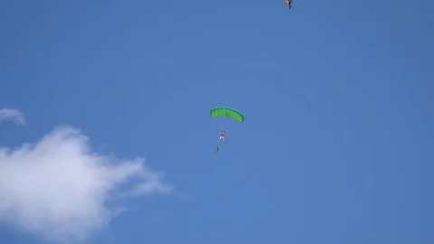 Two parachutists with flags of Ukraine fly across the sky among the clouds Stock Footage