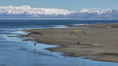 Two Paragliders soaring over the great salt lake in Utah Stock Footage 302947262