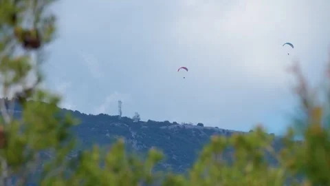 Two paragliders which fly over the mountains of the French Riviera Paragliding Video stock 241524989