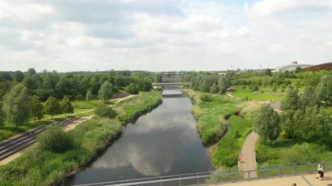 Two parallel bridges over river in park, people spending time in nature Video stock 155847546