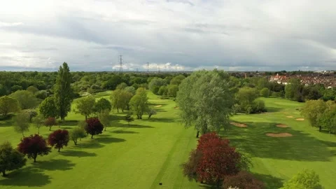 Two parallel fairways on golf course in town in early evening sun Stock Footage 155810596
