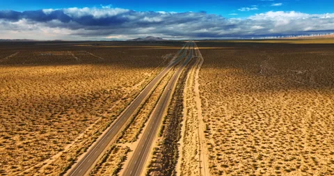 Two parallel highways crossing hot desert in California.  Stock Footage 250699249