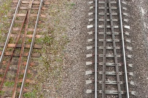 Two parallel railway tracks. top view. On left is old rusty road with wooden  Stock Photos