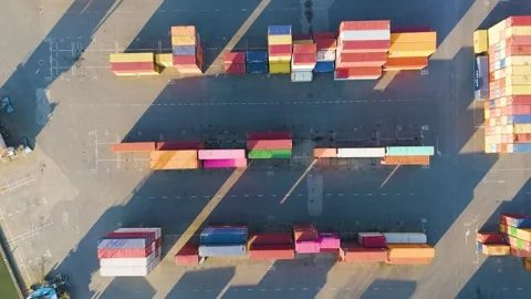 Two parallel rows multicolored shipping containers align along marked lanes vast Stock Footage 329081134