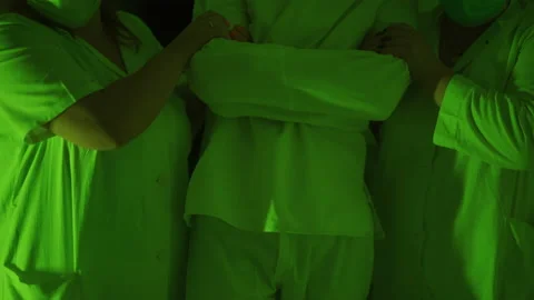 A two paramedic are leading a mad ill male patient in straitjacket down corridor Stock-Footage 161904859