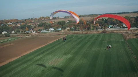 Two paratrikes fly over a rural landscape. Stock Footage 129545905
