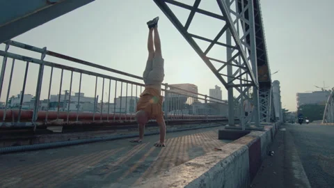 Two Parkourists Performing Partner Stunt in the City Stock Footage 242102232