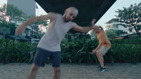 Two Parkourists Performing Side Flips on the Street Stock Footage 242098054