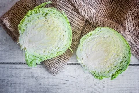 Two part green cabbage on brown sackcloth Stock-Fotos