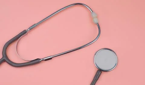 Two part of one single stethoscope isolated on a pink colored background Stock Photos