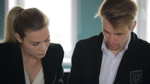 Two partners discuss working project sitting in office in day time Stock Footage 65312258