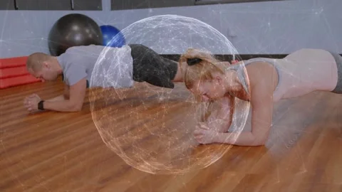 Two partners holding forearm plank while sphere overlay overlapping them, Video stock 322120434
