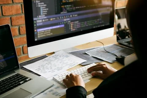 Two partnerships developing programming and coding technologies working on .. 库存照片