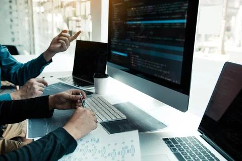 Two partnerships developing programming and coding technologies working on .. Stock Photos