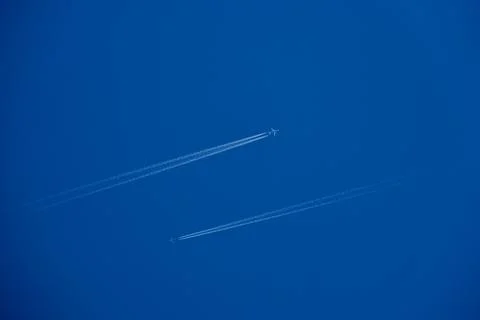 Two Passenger Airplanes Flying in Parallel with Contrails Stock Photos