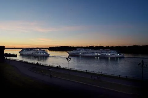 Two passenger liners on the river at sunset Stock Photos
