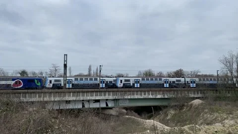 Two passenger trains crossing each other on a tiny bridge Stock Footage 150827712