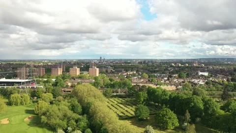Two passenger trains passing by each other on tracks in town Stock-Footage 156706571
