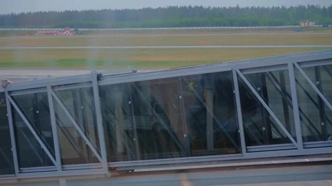 Two passengers boarding on airplane through an airbridge. Stock Footage 97374483