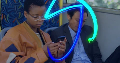Two passengers scrolling smartphones on bus, displaying floating technology Video stock 307436340
