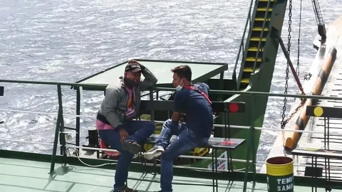 Two Passengers sit on deck ship near Gilimanuk port sea Stock Footage 341660289