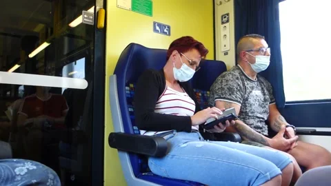 Two passengers in a train wearing covid masks Stock Footage 159090278