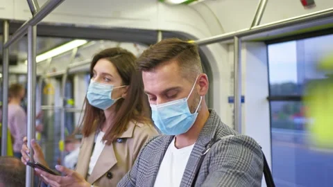 Two passengers wearing protective masks feeling tired while riding at public Stock Footage 160115152