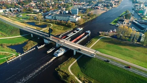 Two Passing Cargo Boats Beneath a Bridge - Friesland, Holland 4K Drone Stock-Footage 126837848