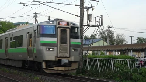 Two passing trains at a level crossing, Chitose, Hokkaido, 2025-05-24. Stock Footage 335736204
