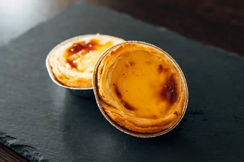 Two Pasteis de Nata on a Black Slate Plate, Simple and Elegant Stock Photos