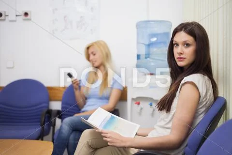 Two Patients Sitting In The Waiting Room