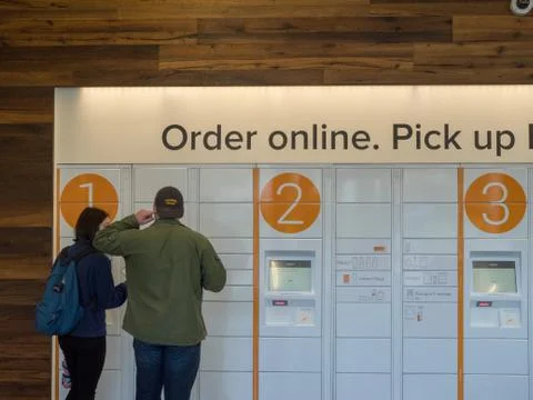 Two patrons using Amazon Locker Stock Photos