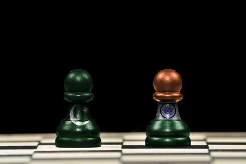 Two pawns chess pieces with the flags of pakistan and india over a chess boar Stock Illustration