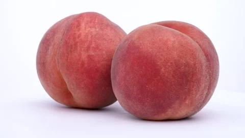 Two peaches turning. Stock Footage 310532084