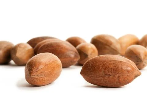 Two pecan nuts in front of many Stock Photos