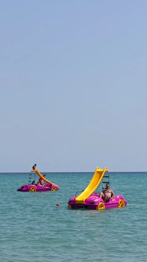 Two Pedal Boats with Slides Floating on Turquoise Sea Stock-Footage 345021703