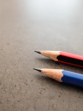 Two pencils on a dark gray table 스톡 사진