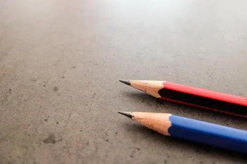 Two pencils on a dark gray table 스톡 사진