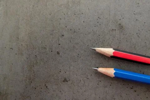 Two pencils on a dark gray table 스톡 사진